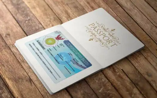 Passport with a blue and white design on a wooden surface.