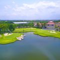 Aerial view of golf course with clubhouse and lake