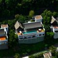Aerial view of luxury hillside villas with pools