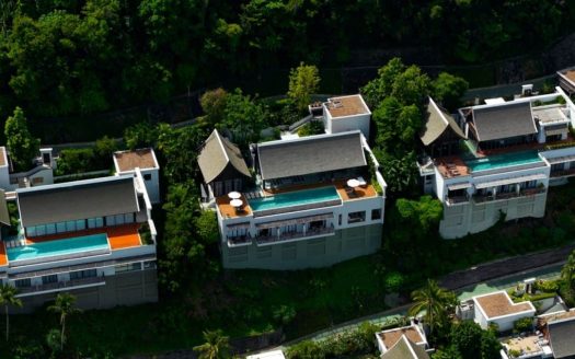 Aerial view of luxury hillside villas with pools