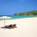Sun loungers and umbrella on tropical sandy beach