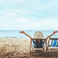 Person relaxing in deckchair on sunny beach