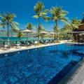 Luxury beachfront villa with infinity pool and palms