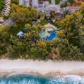Aerial view of beachfront resort and turquoise sea