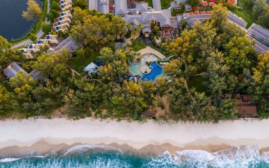 Aerial view of beachfront resort and turquoise sea