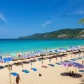 Colourful umbrellas on tropical beach with turquoise sea