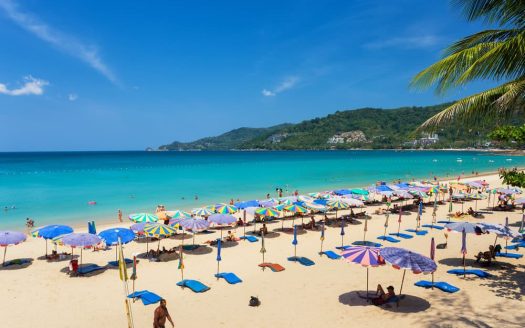Colourful umbrellas on tropical beach with turquoise sea