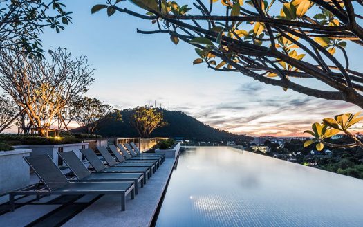 Rooftop infinity pool overlooking hills at sunset