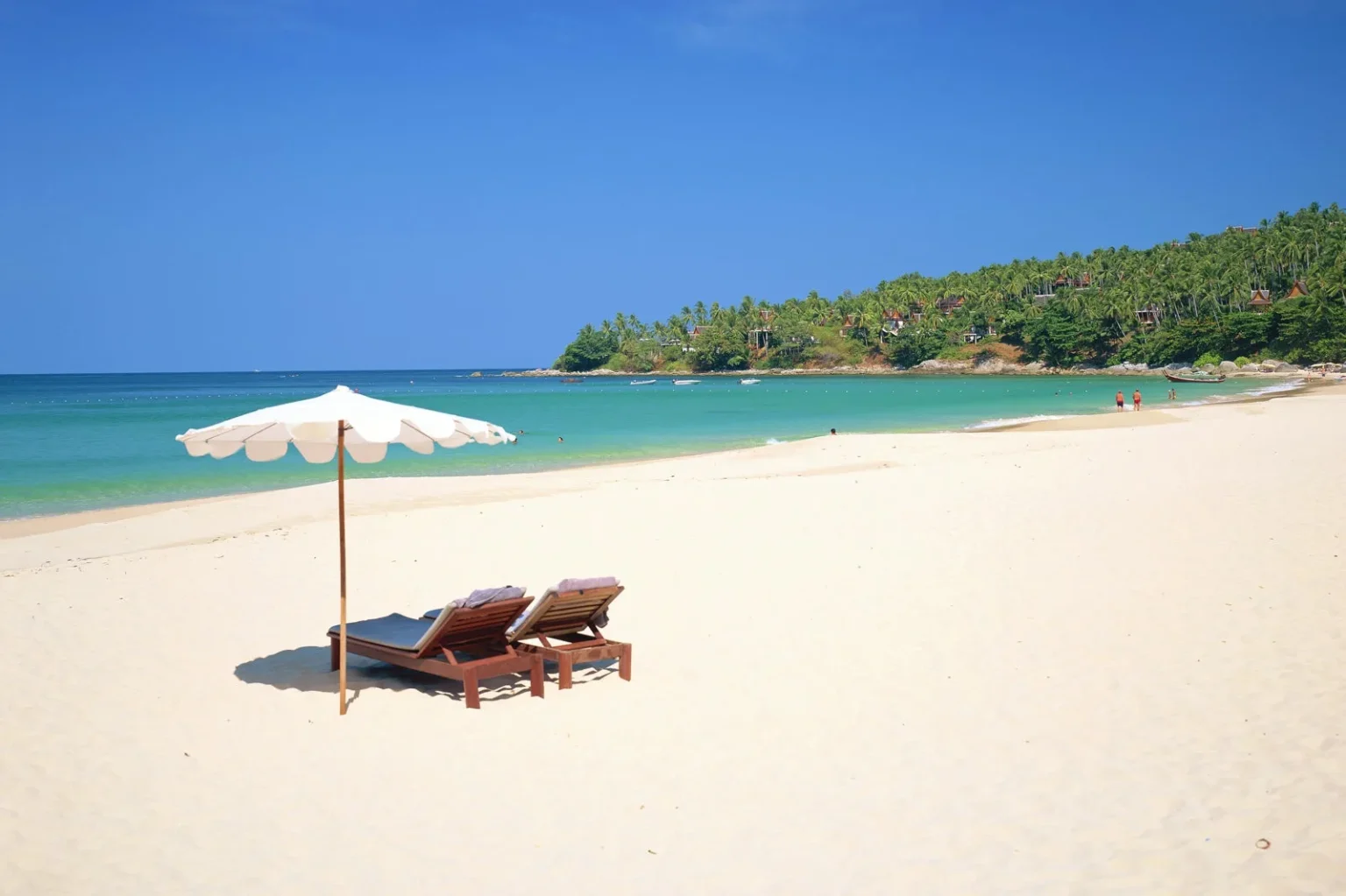 Sun loungers and umbrella on tropical sandy beach
