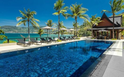 Luxury beachfront villa with infinity pool and palms