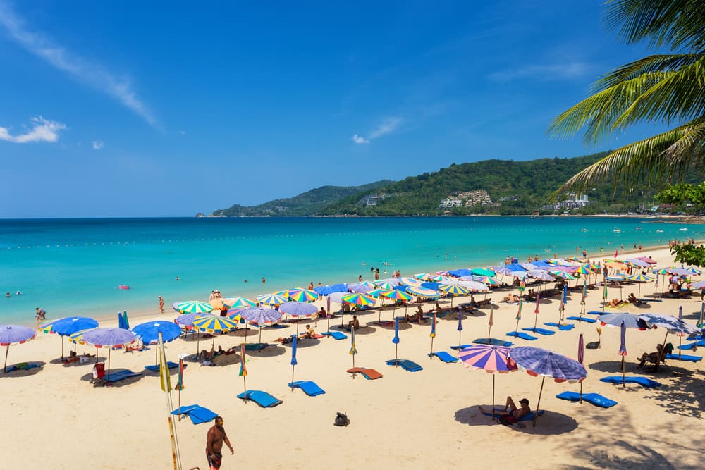 Colourful umbrellas on tropical beach with turquoise sea