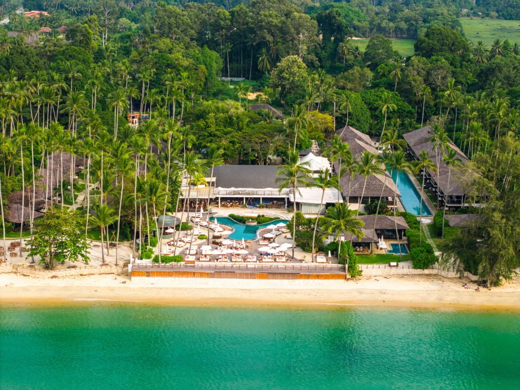 Aerial view of tropical beachfront resort with pool