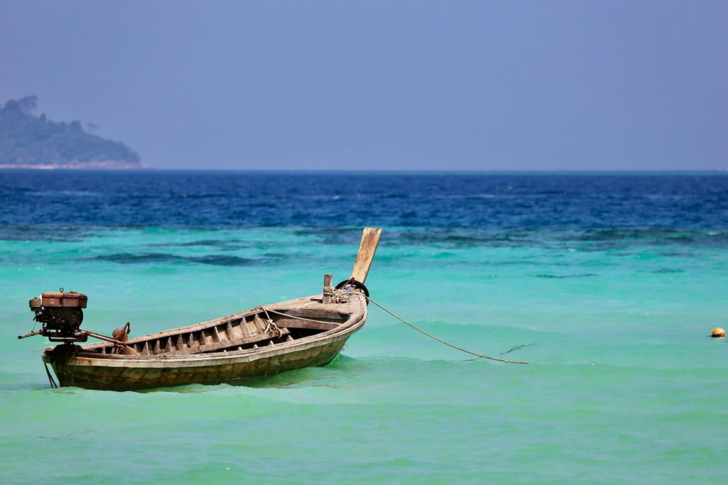 Wooden long-tail boat in turquoise sea