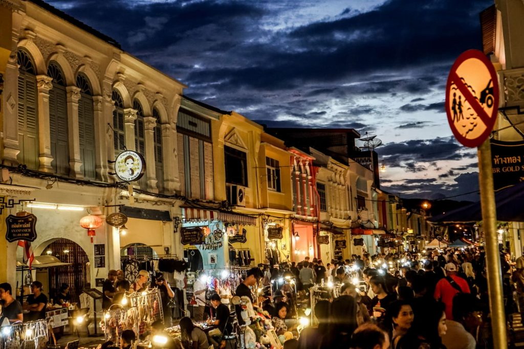 Bustling night market on historic street at dusk