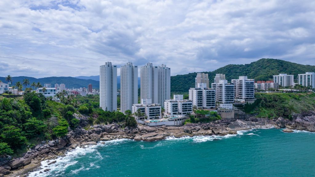 High-rise apartments overlooking rocky turquoise coastline