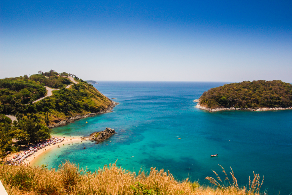 Turquoise bay with sandy beach and green headlands