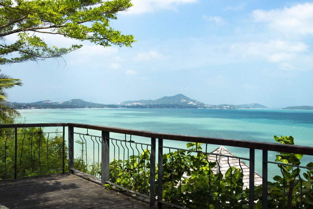 Balcony overlooking turquoise sea and distant islands